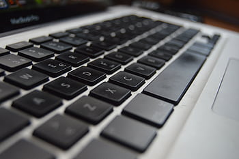 Detailed close-up of a laptop keyboard showcasing technology and productivity aspects. HD wallpaper