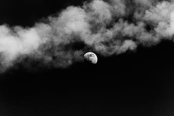 A captivating black and white of the moon partially obscured by clouds against a dark sky. HD wallpaper