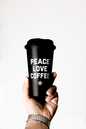 Close-up of a hand holding a coffee cup with 'Peace Love Coffee' text, promoting positivity. HD phone wallpaper