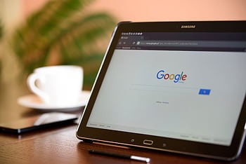 Samsung tablet on desk showing Google homepage, perfect for technology-related content. HD wallpaper