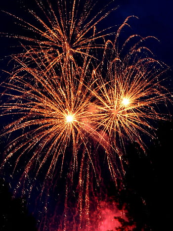 Bright and colorful fireworks display lighting up the night sky, perfect for celebrations and festive occasions. HD phone wallpaper