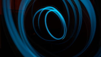 Captivating abstract light painting featuring illuminated blue circles on a dark background. HD wallpaper