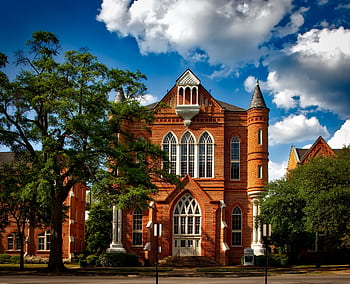 Captivating view of Clark Hall at the University of Alabama with its iconic brick facade. HD wallpaper