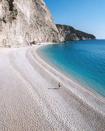 Aerial shot of Porto Katsiki Beach showing clear turquoise waters and dramatic cliffs, perfect summer escape. HD phone wallpaper