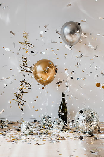 Celebrate the New Year with balloons, confetti, and disco balls in a festive indoor setting. HD phone wallpaper