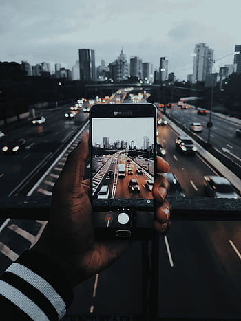 Capturing the vibrant twilight cityscape of Sao Paulo through a mobile lens on a bustling highway. HD phone wallpaper