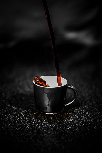 Close-up of steaming dark coffee being poured into a black cup on a dark textured surface. Rich aroma. HD phone wallpaper