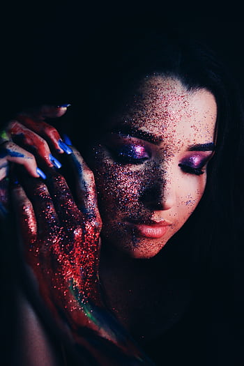 Portrait of a young woman with colorful glitter and vibrant makeup displaying creativity and elegance. HD phone wallpaper