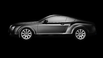A side profile of a luxurious black coupe on a plain black background, showcasing elegance. HD wallpaper