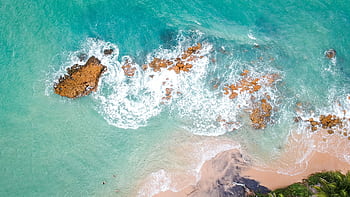 Stunning aerial shot of a Brazilian beach with turquoise waters and rocky coastline. HD wallpaper