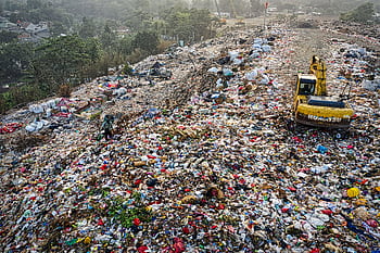 Aerial shot of a waste landfill in South Tangerang, showcasing pollution issues. HD wallpaper
