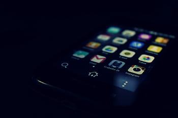 Dark-themed close-up of a smart screen highlighting various apps and touchscreen technology. HD wallpaper