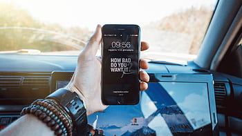 Close-up of a hand holding a smart in a car, highlighting technology and motivation. HD wallpaper