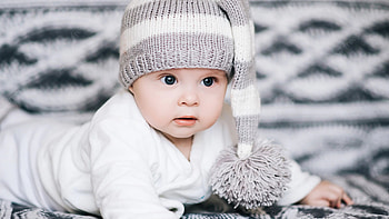Cute Baby Boy Is Lying Down On Cloth Wearing White Dress And Woolen Knitted Cap Cute HD wallpaper