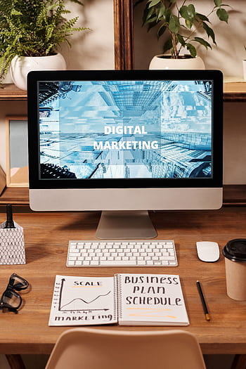 Contemporary office setup featuring digital marketing strategy on a computer screen, ideal for business technology themes. HD phone wallpaper