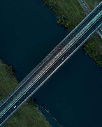 Drone shot capturing a bridge over a river in Leonay, NSW, showcasing transportation and nature. HD phone wallpaper