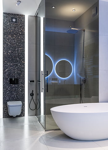 Sleek modern bathroom featuring a standing tub and illuminated shower area. HD phone wallpaper