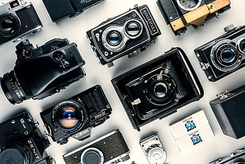 Flat lay of various vintage cameras showcasing classic design and retro charm. HD wallpaper