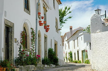 Explore the scenic whitewashed architecture of Marvão, Portugal, showcasing traditional cobblestone streets and historic charm. HD wallpaper