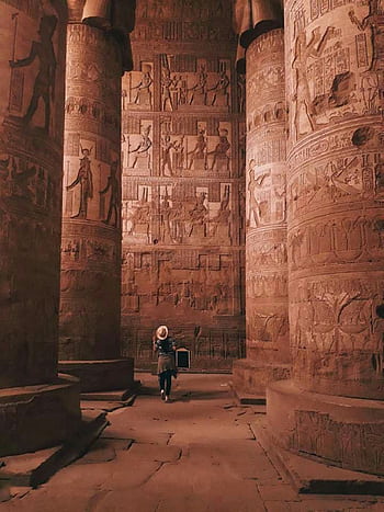 Tourist exploring the intricately carved columns of Dendera Temple, Egypt. HD phone wallpaper