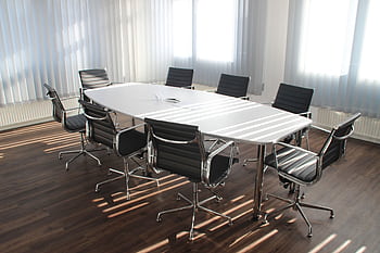 Modern office meeting room with designer chairs, table, and large windows. HD wallpaper