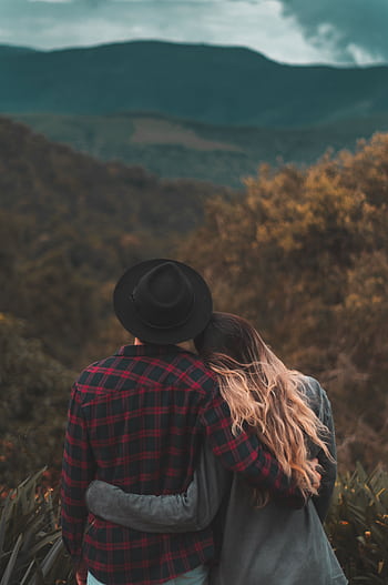 Romantic couple embraces while enjoying a beautiful scenic view of hills during daytime. HD phone wallpaper