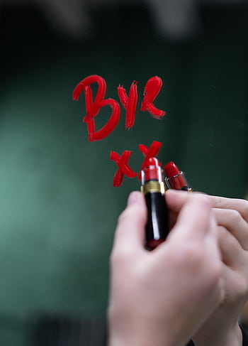 Handwriting 'bye' on a mirror with red lipstick, evoking themes of farewell and emotion. HD phone wallpaper