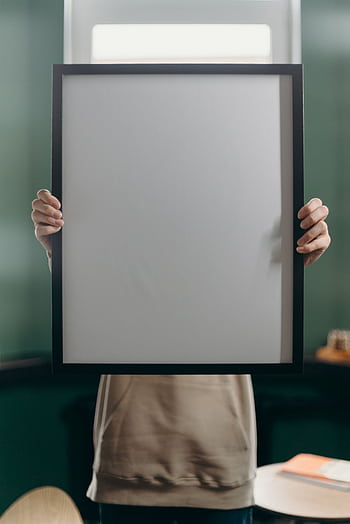 An anonymous individual holding a blank black frame, perfect for art or mockups. HD phone wallpaper