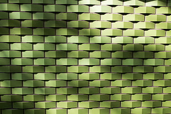 Textured green tile wall with geometric pattern and light shadows, ideal for backgrounds. HD wallpaper