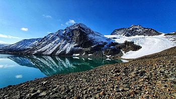 A place in Northern Sweden, called the Tarfala valley, stones, mountain, reflections, snow, sky, water HD wallpaper