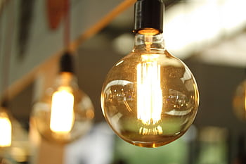 A close-up of a glowing vintage Edison bulb creating a warm atmosphere. HD wallpaper