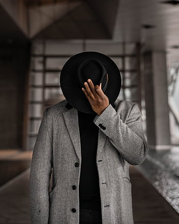 Elegant of a man in a formal coat and fedora hat posing indoors. HD phone wallpaper
