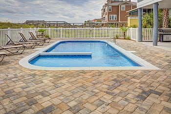 Relaxing poolside patio with sun loungers and villas, perfect for a summer retreat. HD wallpaper