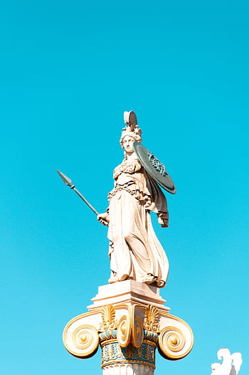 Elegant Greek statue of Athena in Athens against a vivid blue sky, showcasing classical artistry. HD phone wallpaper