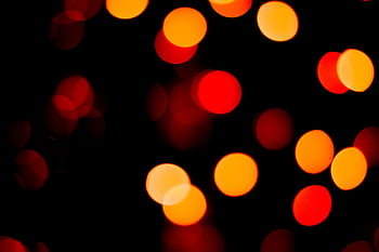 Vivid bokeh lights in red and orange create a captivating abstract background. HD wallpaper
