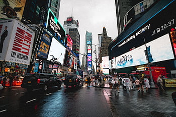 Night view of Times Square in NYC with illuminated billboards and a lively crowd. HD wallpaper