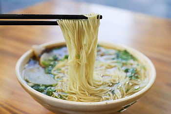 Savor the mouthwatering taste of fresh ramen noodles lifted by chopsticks. HD wallpaper
