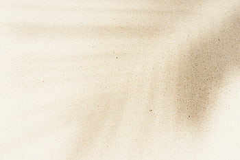 Artistic sand texture with natural shadows creating a serene abstract pattern, perfect for background use. HD wallpaper