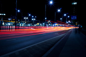Vivid long exposure captures urban night traffic with stunning light trails. HD wallpaper