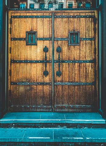 Close-up of vintage wooden doors featuring ornate ironwork and bolts. HD phone wallpaper