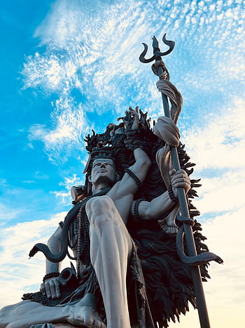 Low angle shot of the Azhimala Shiva statue in KL, India, depicting Hindu religious art. HD phone wallpaper