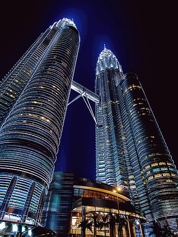 Stunning nighttime view of the illuminated Petronas Towers in Kuala Lumpur, Malaysia. HD phone wallpaper