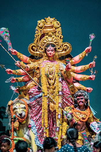 Brightly adorned statue of Hindu goddess Durga displayed during an Indian cultural festival. HD phone wallpaper