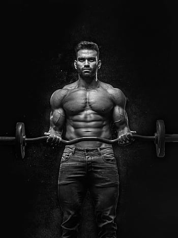 Black and white portrait of a muscular man lifting weights, showcasing strength and fitness. HD phone wallpaper