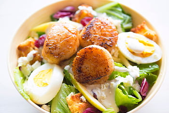 Delicious scallop salad with boiled eggs and fresh greens, perfect for a healthy meal. HD wallpaper