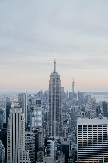 Iconic New York skyline featuring the Empire State Building during daytime. HD phone wallpaper