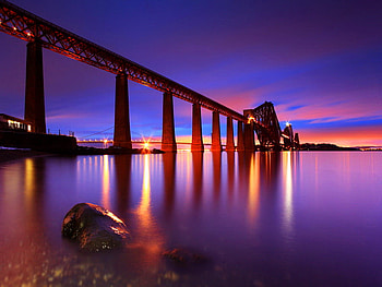 Bridge over the sea at night, night, sea, colorful, colors, peaceful, beach, reflection, lights, bridge, clouds, nature, sky, water HD wallpaper