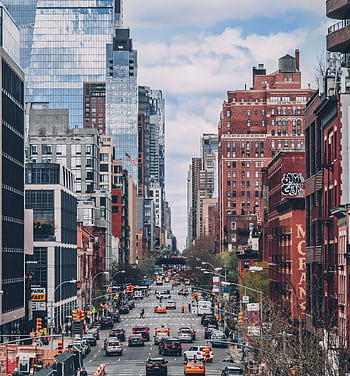 Bustling street scene in NYC with iconic skyscrapers and busy traffic. HD phone wallpaper