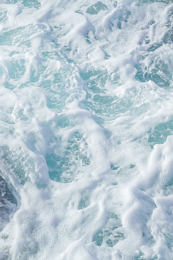 A close-up of swirling sea foam and turquoise waves at San Diego's coastline. HD phone wallpaper