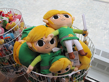 Toon Links and Yoshi's in a basket, yoshis, colorful, toon link, air vent, white, mario, plushies, basket, swords, green, cat eyes, zelda, video games HD wallpaper